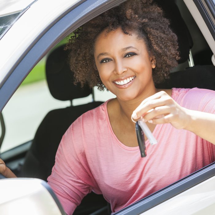 Happy Atlanta AutoStar customer holding her car key